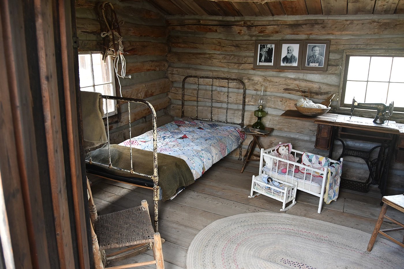 Bed and stove inside an authentic 1800s cabin