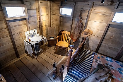 The cabin restroom at the food of a bed
